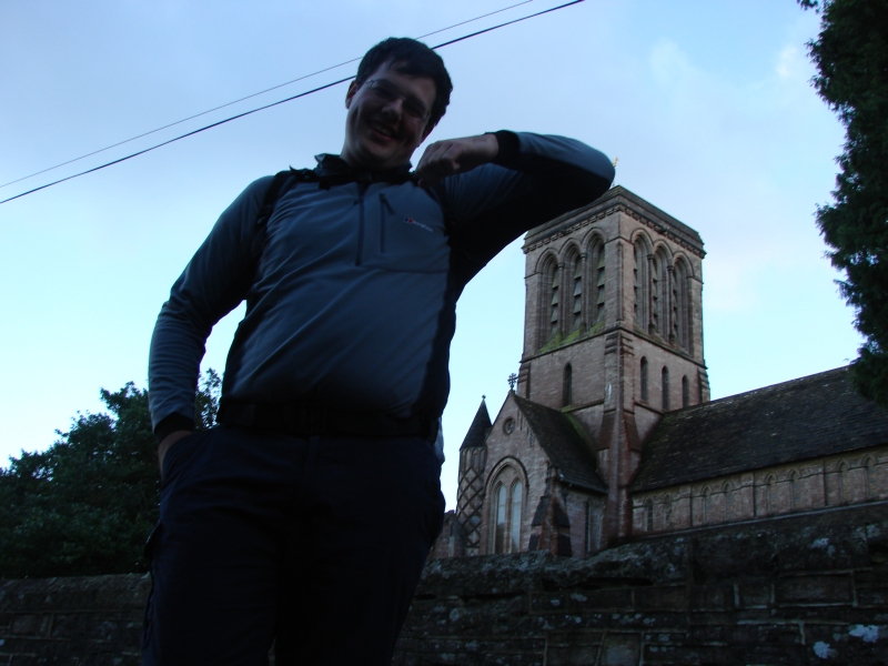 A member of Southampton Walking club leaning against a church